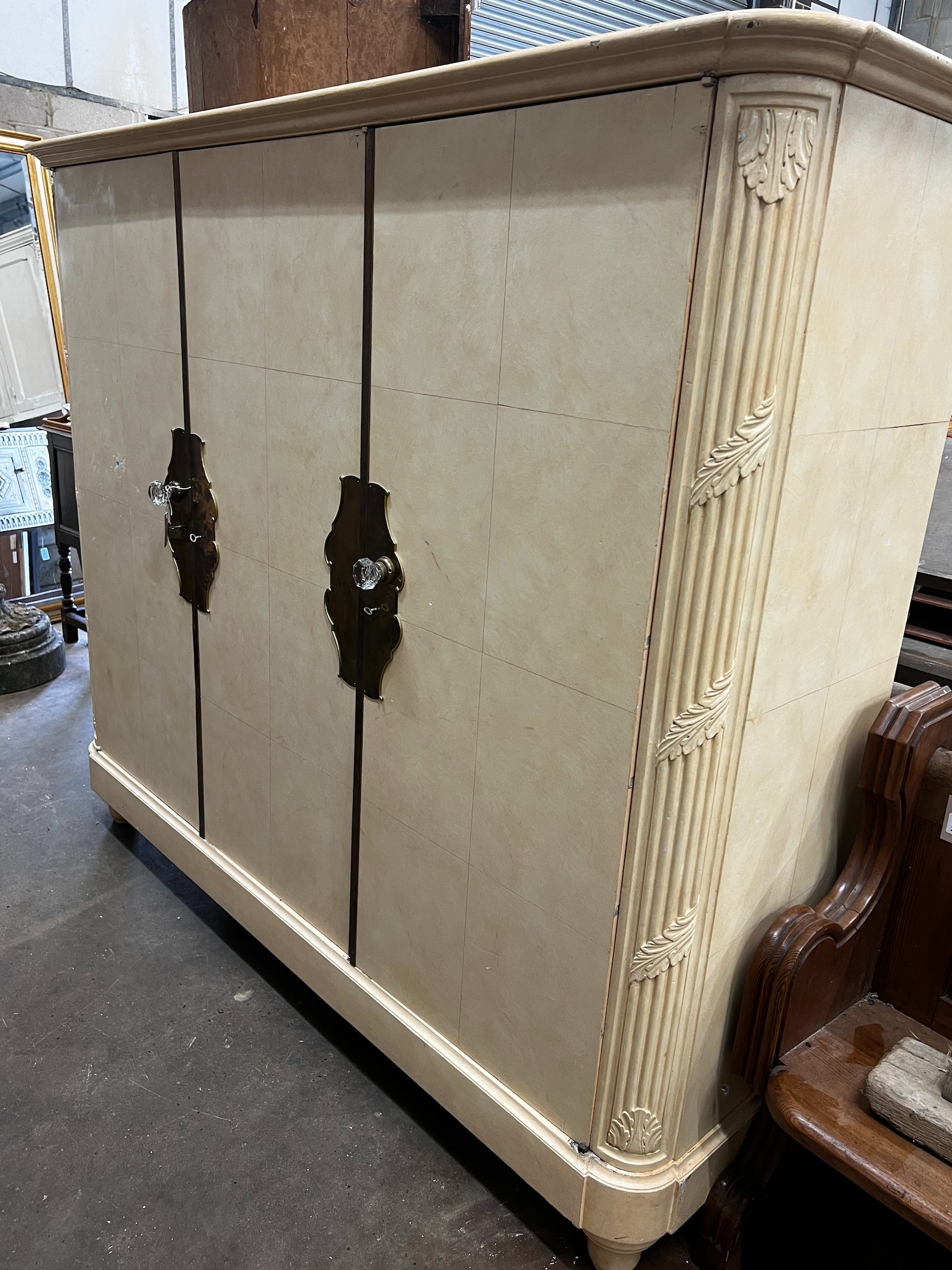 An early 20th century French brass mounted oak compactum wardrobe, width 196cm depth 56cm height 170cm